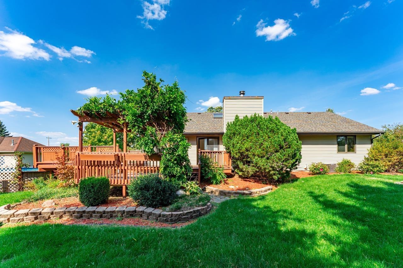7467 McCurry Road Roscoe, IL 61073 - Photo 27 of 29 a view of a house with a yard and a garden