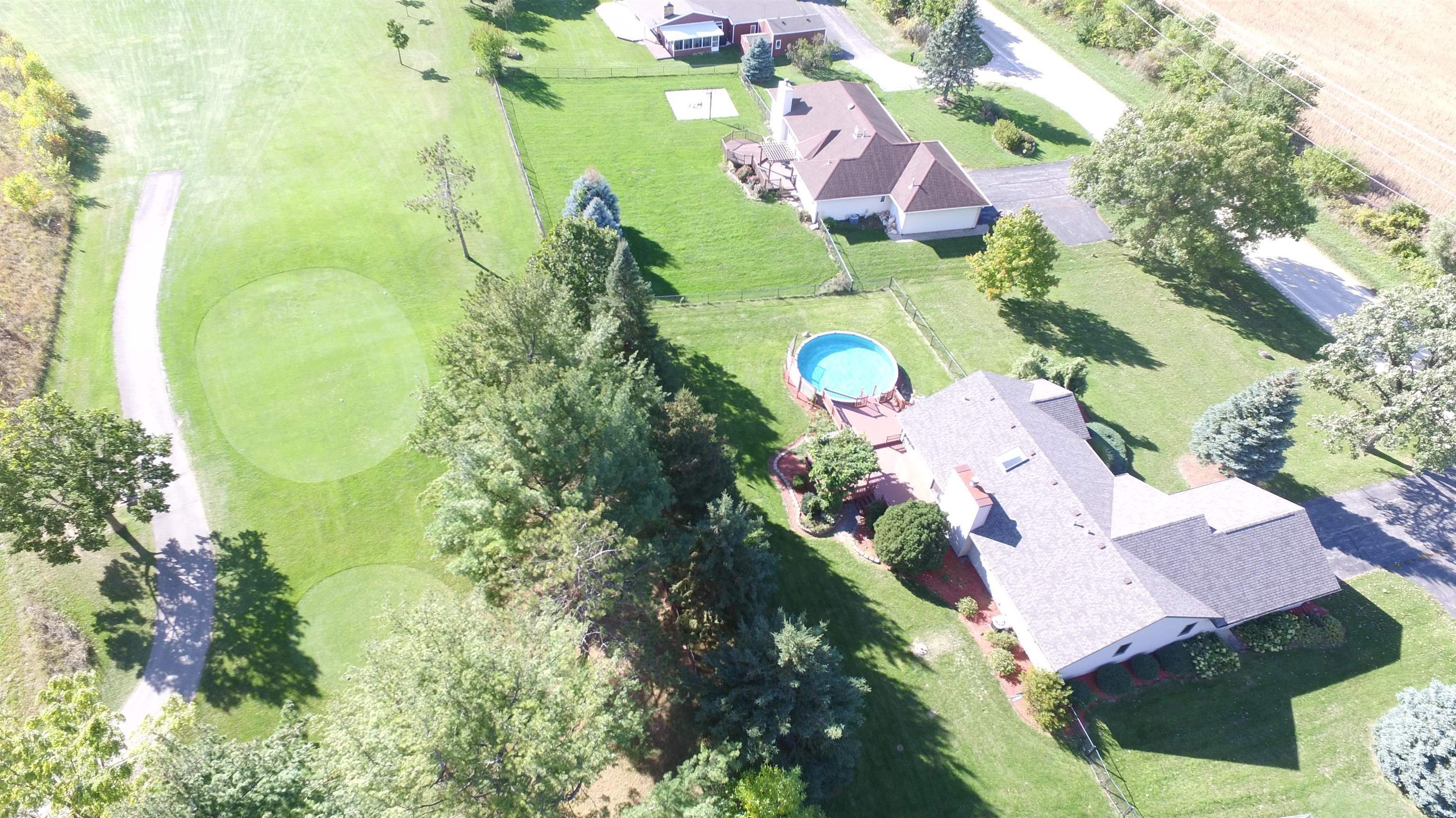 7467 McCurry Road Roscoe, IL 61073 - Photo 28 of 29 an aerial view of a house with swimming pool and garden space
