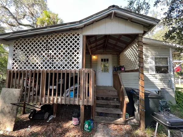 a view of a house with a wooden deck