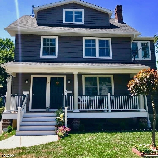 a view of a house with a yard deck and a chair