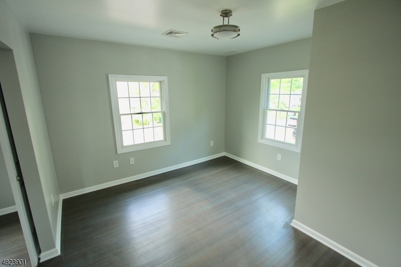18 William Street, Unit 2 Summit, NJ 07901 - Photo 12 of 15 a view of an empty room with wooden floor and a window
