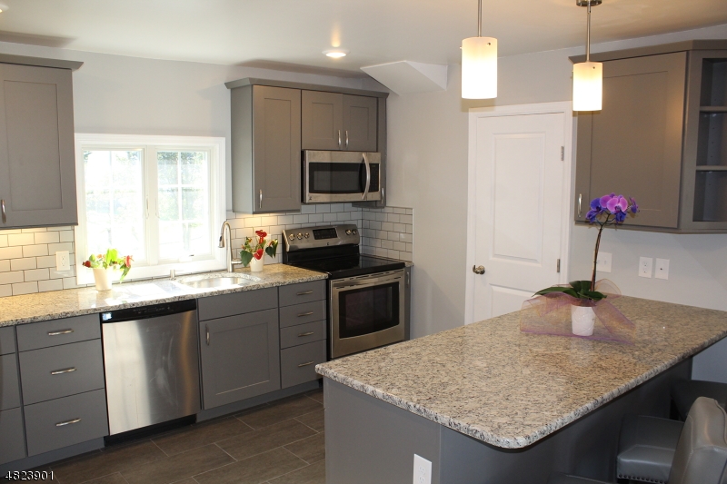 18 William Street, Unit 2 Summit, NJ 07901 - Photo 2 of 15 a kitchen with a sink refrigerator and microwave