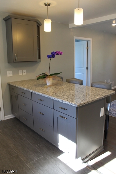 18 William Street, Unit 2 Summit, NJ 07901 - Photo 5 of 15 a bathroom with a granite countertop sink and a mirror