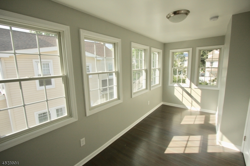 18 William Street, Unit 2 Summit, NJ 07901 - Photo 6 of 15 a view of an empty room with wooden floor and a window