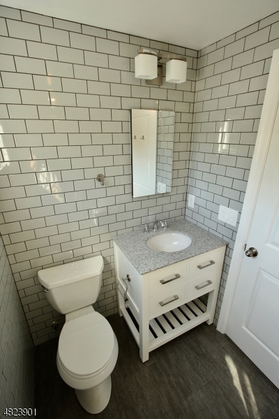 18 William Street, Unit 2 Summit, NJ 07901 - Photo 9 of 15 a bathroom with a granite countertop toilet and a sink