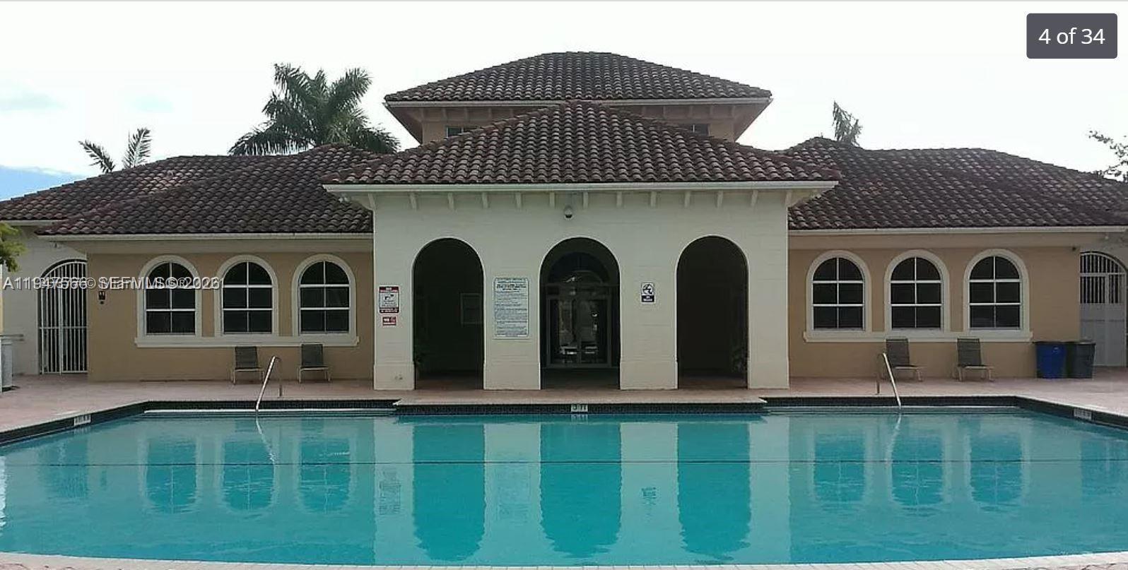 4913 Southwest 141st Avenue, Unit 2 Miramar, FL 33027 - Photo 5 of 12 a front view of a house with garden
