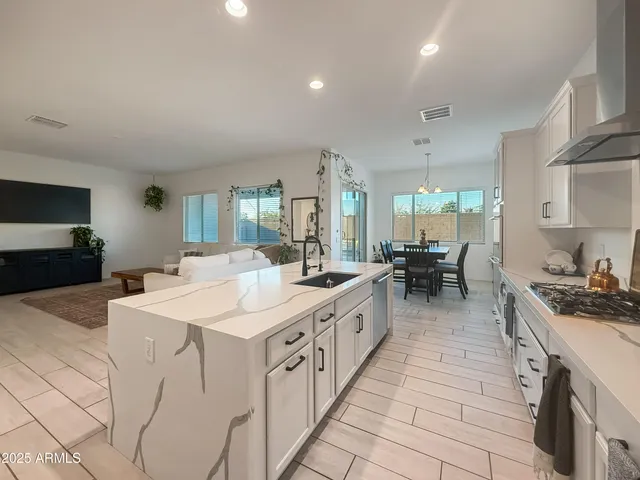 a kitchen with stainless steel appliances kitchen island granite countertop a sink and cabinets