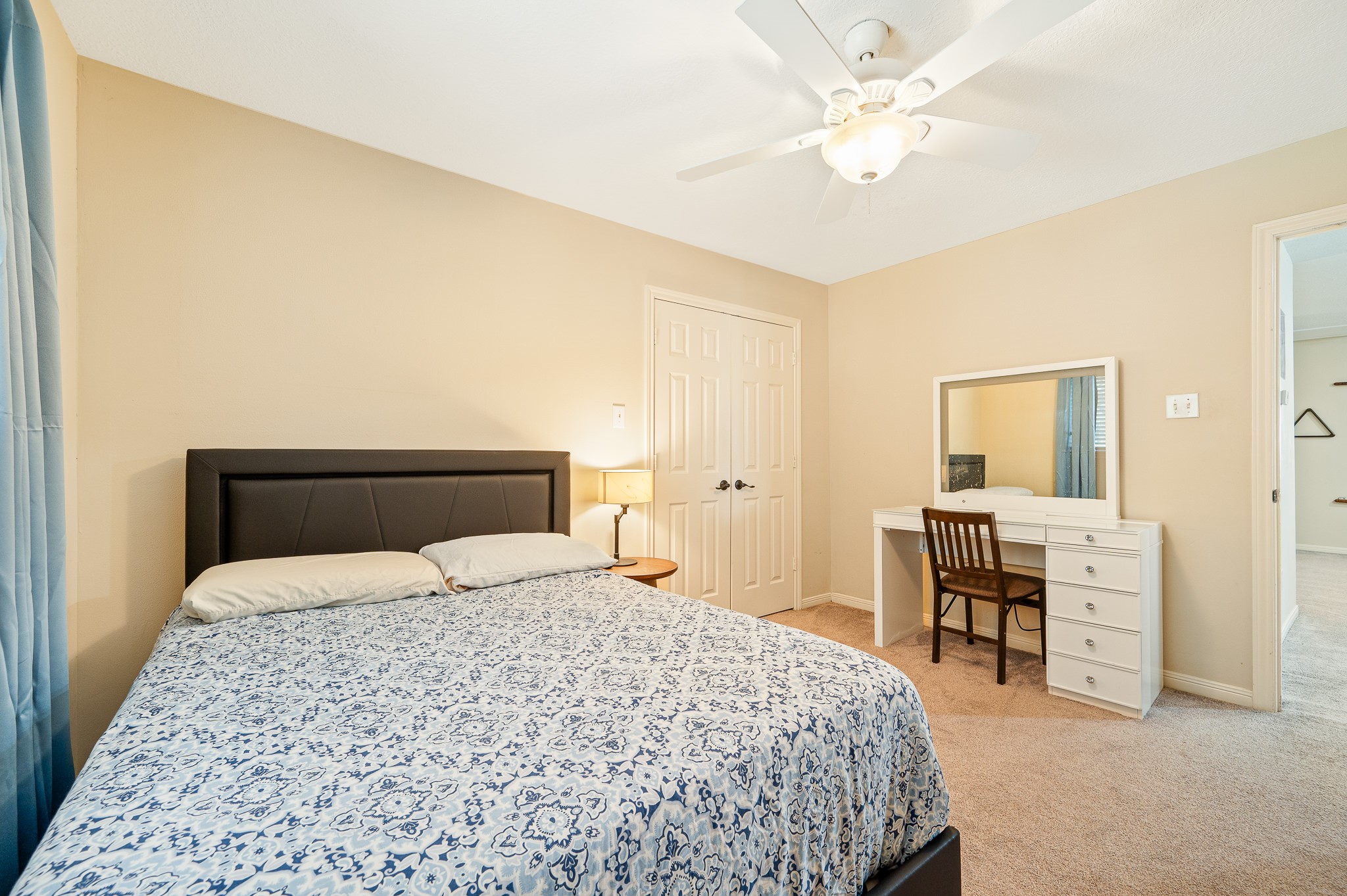 8111 Morningbrook Court Spring, TX 77379 - Photo 35 of 46 a bedroom with a bed and a chandelier