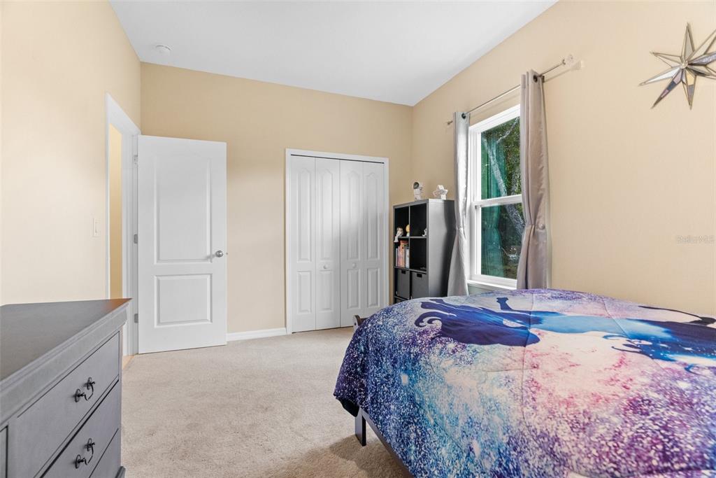 6283 Grapewood Road Spring Hill, FL 34609 - Photo 32 of 41 a bedroom with a bed and a window
