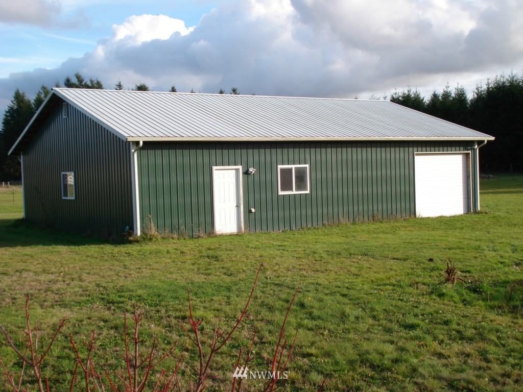 7325 187th Court Southwest Rochester, WA 98579 - Photo 2 of 9 a front view of a house with garden