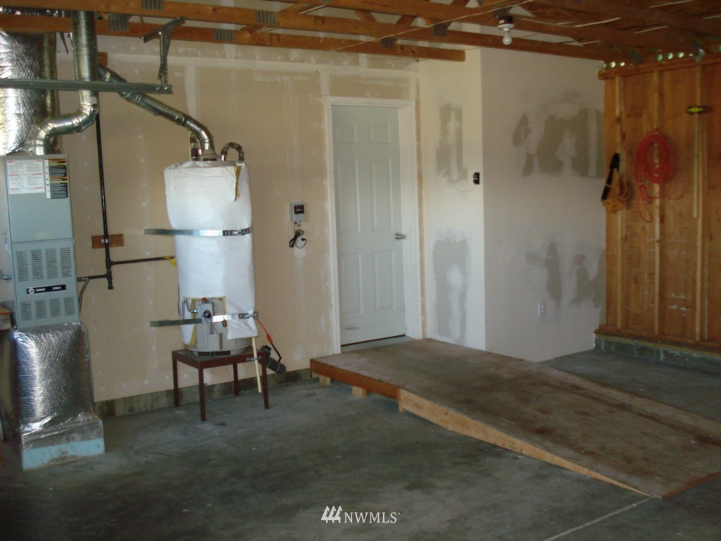 7325 187th Court Southwest Rochester, WA 98579 - Photo 8 of 9 a view of empty room with wooden floor