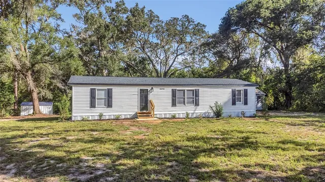 a house that has a tree in front of the house