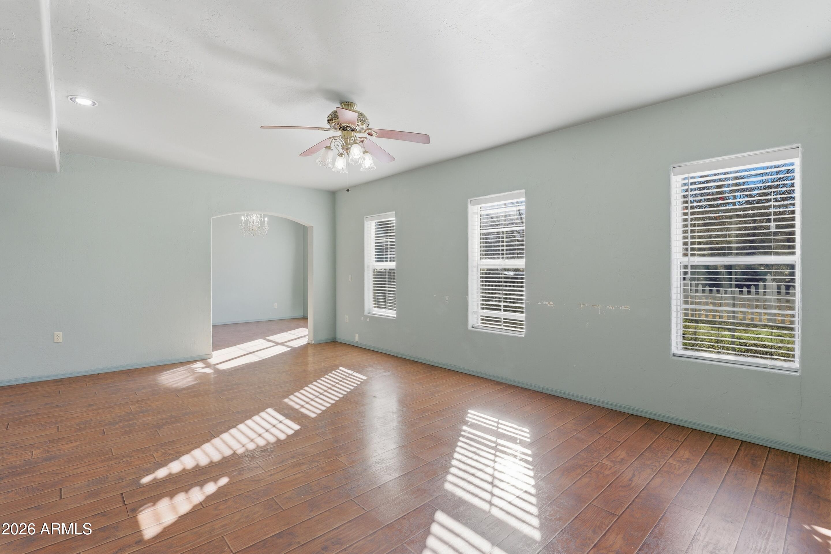 228 Windmill Road Payson, AZ 85541 - Photo 21 of 42 a view of an empty room with wooden floor and a window