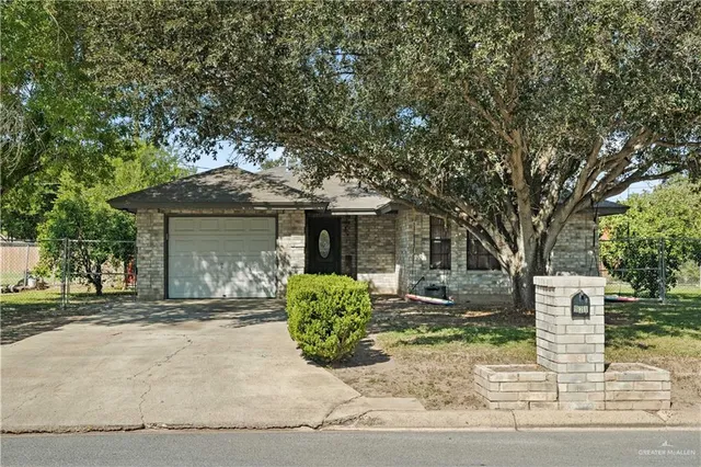 front view of a house with a tree