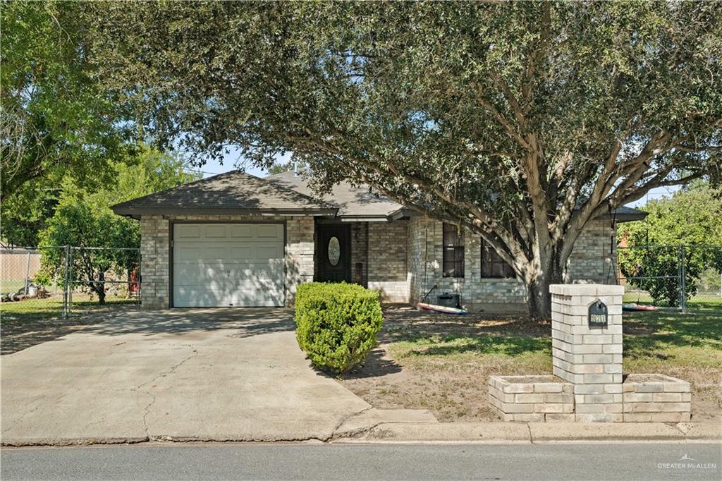 front view of a house with a tree
