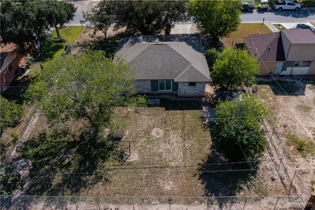 an aerial view of a house with a yard and garden
