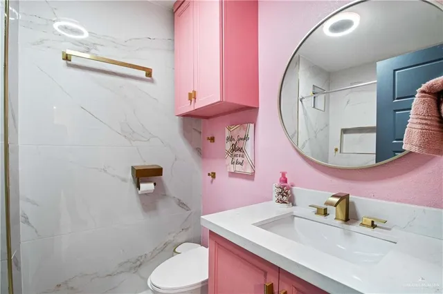 a bathroom with a sink a toilet and a mirror