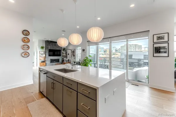 a kitchen with a sink and dishwasher with a large window