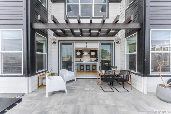 a building outdoor space with patio furniture and potted plants