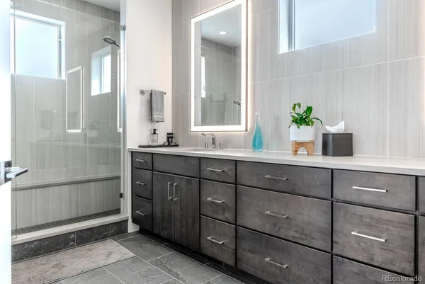 a bathroom with a granite countertop sink mirror and double