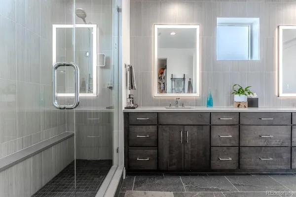 a bathroom with a granite countertop sink a vanity and a mirror
