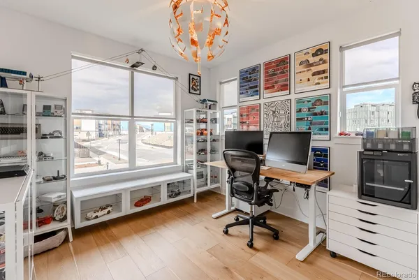 a view of a workspace with furniture and a window