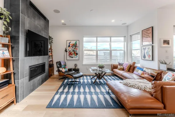 a living room with fireplace furniture and a flat screen tv