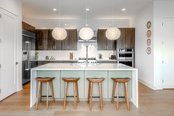 a kitchen with a table chairs sink and cabinets