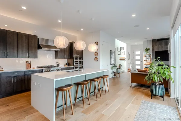 a large kitchen with cabinets table and chairs