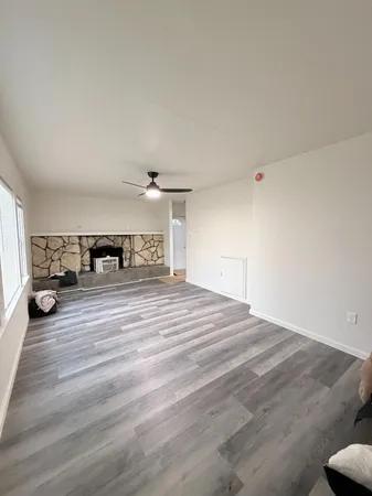 a bedroom with a bed and a car parked