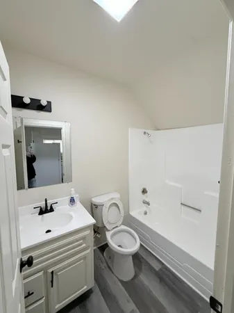 a bathroom with a sink toilet and mirror