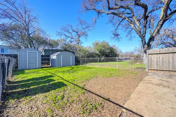 a view of a backyard with large trees