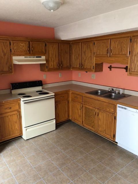 698 Needmore Road Clarksville, TN 37040 - Photo 4 of 13 a kitchen with granite countertop a stove top oven sink and cabinets