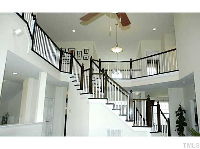702 Ivyshaw Road Cary, NC 27519 - Photo 12 of 25 View of floating staircase from the family room. Large landing above and 4 additional upstairs bedrooms. Staircase