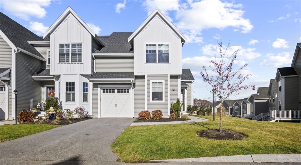 a front view of a house with a yard and garage
