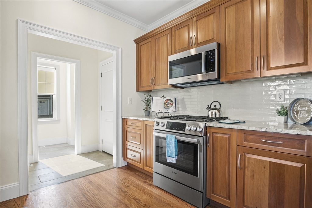 16 Winning Farm Road, Unit 16 Woburn, MA 01801 - Photo 12 of 42 a kitchen with stainless steel appliances granite countertop a stove microwave and sink