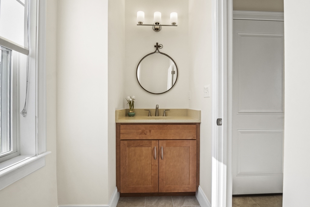 16 Winning Farm Road, Unit 16 Woburn, MA 01801 - Photo 13 of 42 a bathroom with a granite countertop sink a mirror and a