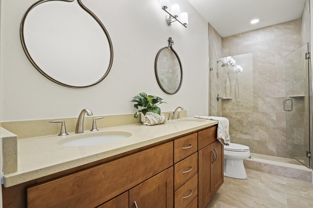 16 Winning Farm Road, Unit 16 Woburn, MA 01801 - Photo 16 of 42 a bathroom with a double vanity sink and a mirror