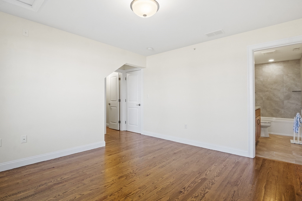 16 Winning Farm Road, Unit 16 Woburn, MA 01801 - Photo 18 of 42 a view of an empty room with wooden floor