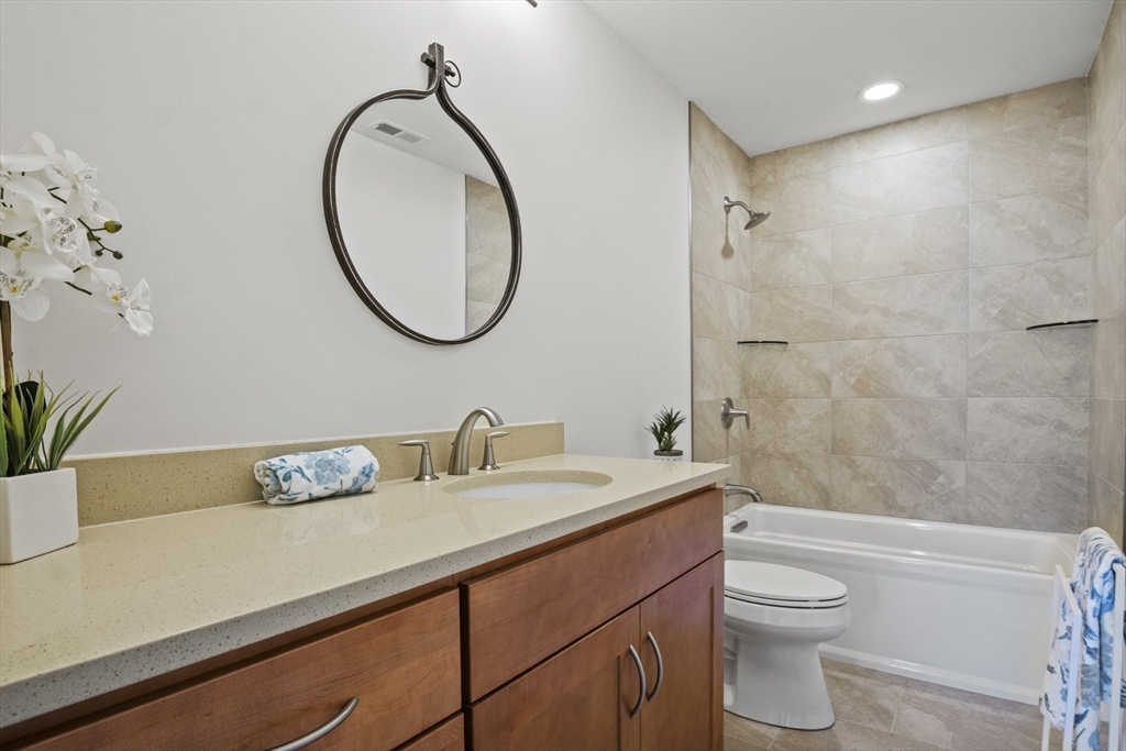 16 Winning Farm Road, Unit 16 Woburn, MA 01801 - Photo 19 of 42 a bathroom with a sink a toilet and a mirror