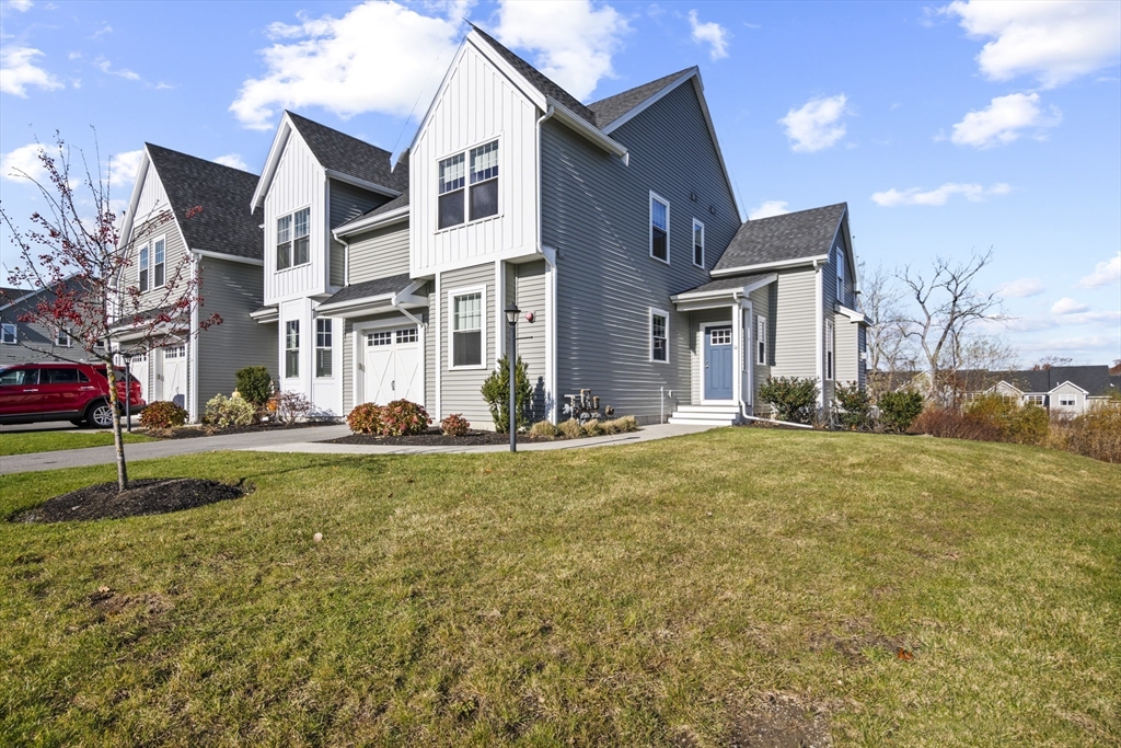 16 Winning Farm Road, Unit 16 Woburn, MA 01801 - Photo 2 of 42 a view of a house with a big yard and large tree