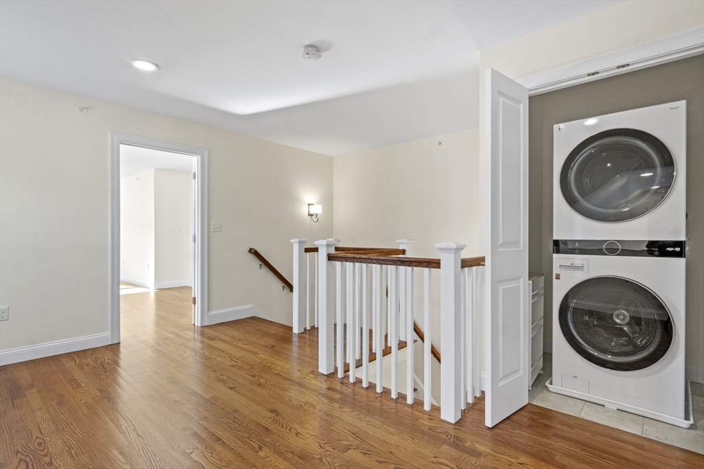 16 Winning Farm Road, Unit 16 Woburn, MA 01801 - Photo 27 of 42 a view of a hallway with washer and dryer