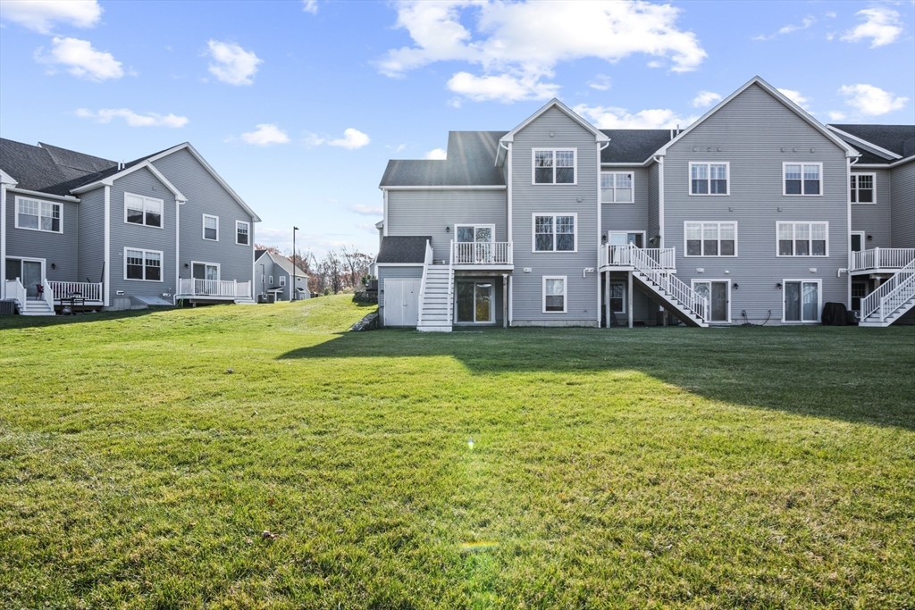 16 Winning Farm Road, Unit 16 Woburn, MA 01801 - Photo 33 of 42 a view of a big house with a big yard and large trees