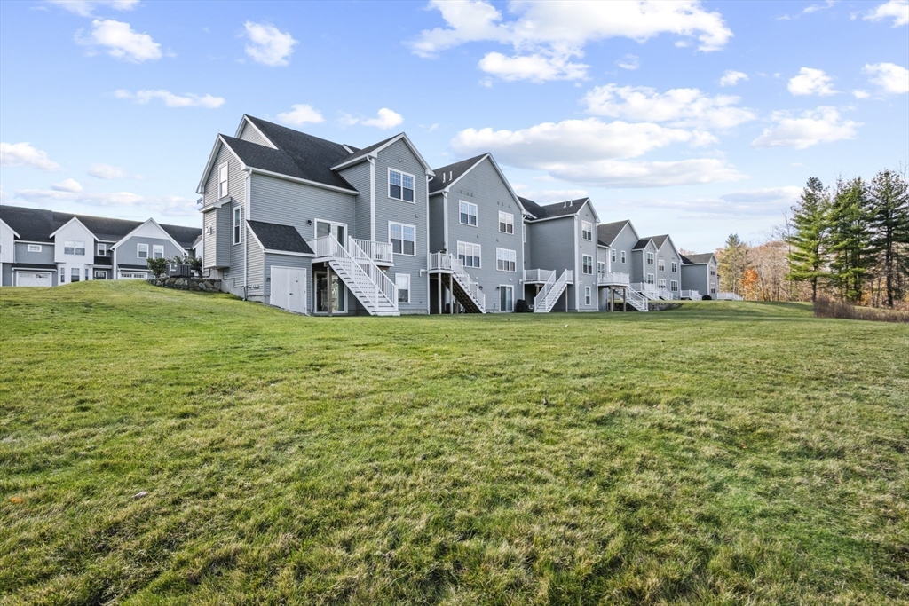 16 Winning Farm Road, Unit 16 Woburn, MA 01801 - Photo 34 of 42 a view of a big house with a big yard and large trees