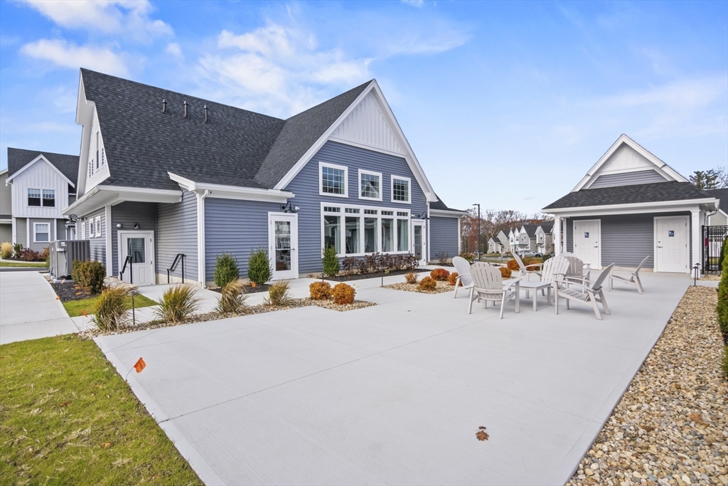 16 Winning Farm Road, Unit 16 Woburn, MA 01801 - Photo 41 of 42 a view of a white house with swimming pool in front of it
