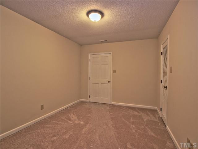 2701 Smokey Ridge Road Raleigh, NC 27613 - Photo 18 of 25 Flex room in the basement, works as a great office with door leading to the backyard. Studio/Study/Office