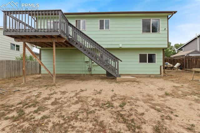 604 Wheat Field Road Fountain, CO 80817 - Photo 28 of 33 Rear view of property with a wooden deck