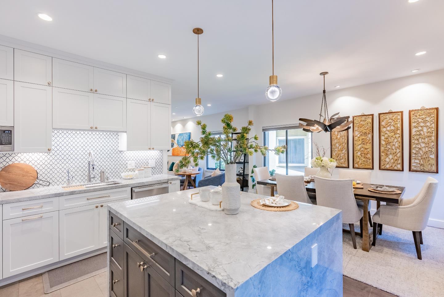 919 La Mesa Terrace, Unit E Sunnyvale, CA 94086 - Photo 12 of 34 a kitchen with a stove a sink a kitchen island with chairs and wooden cabinets