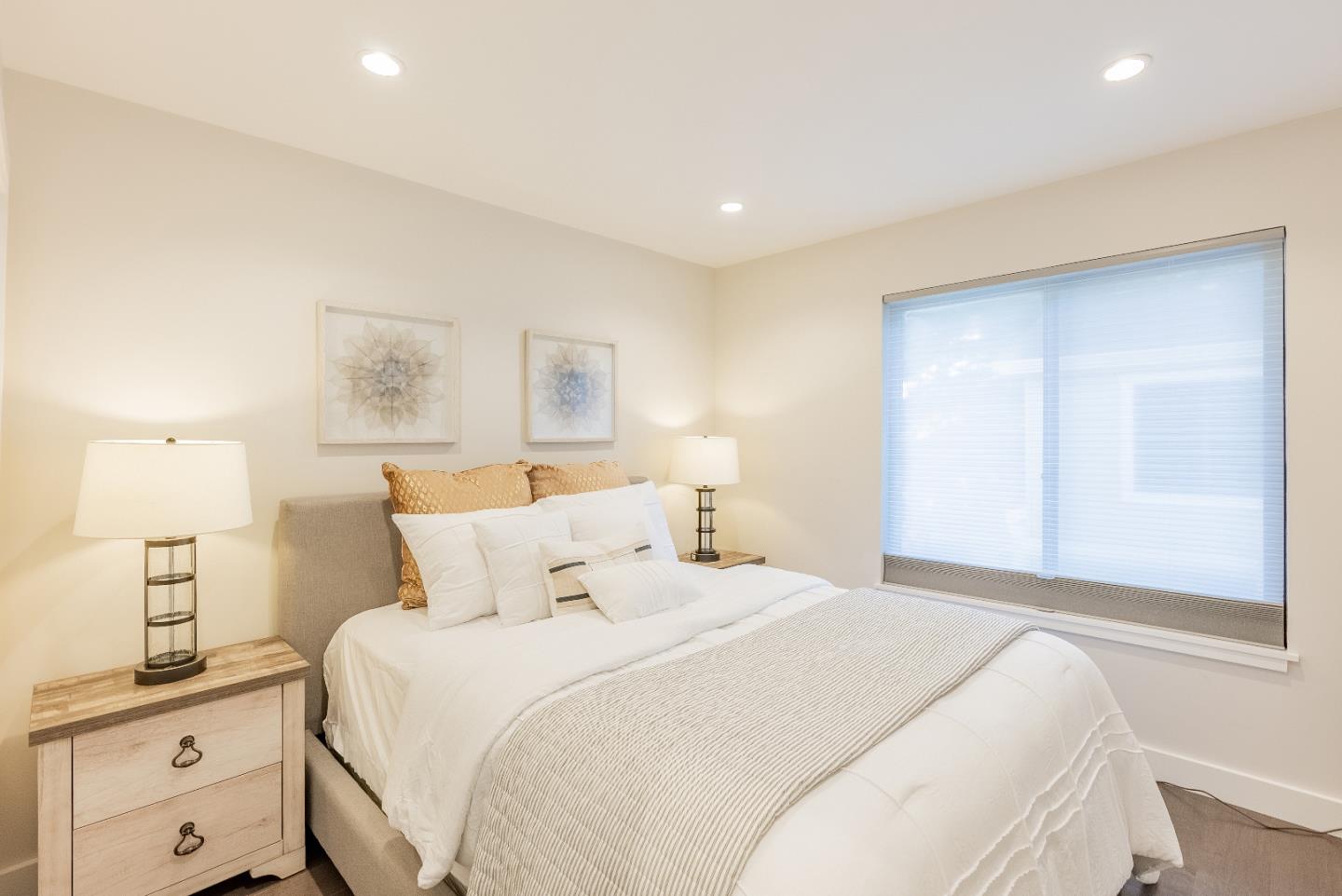 919 La Mesa Terrace, Unit E Sunnyvale, CA 94086 - Photo 16 of 34 a bedroom with a bed and a night stand