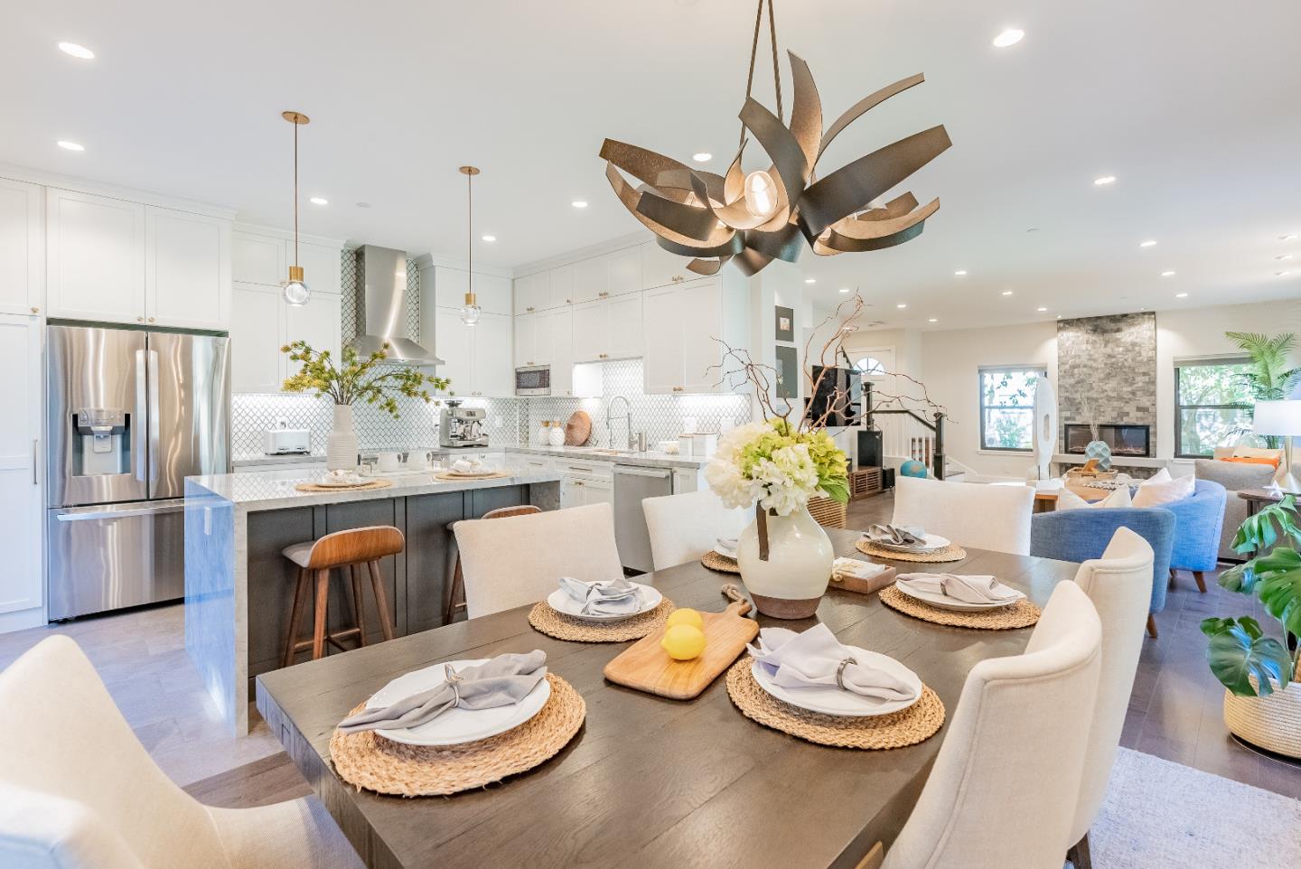 919 La Mesa Terrace, Unit E Sunnyvale, CA 94086 - Photo 5 of 34 a kitchen with stainless steel appliances kitchen island granite countertop a dining table and chairs